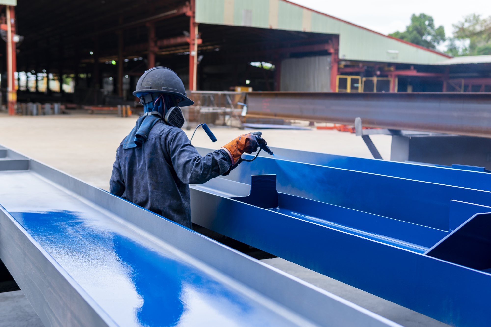 worker painting steel beam