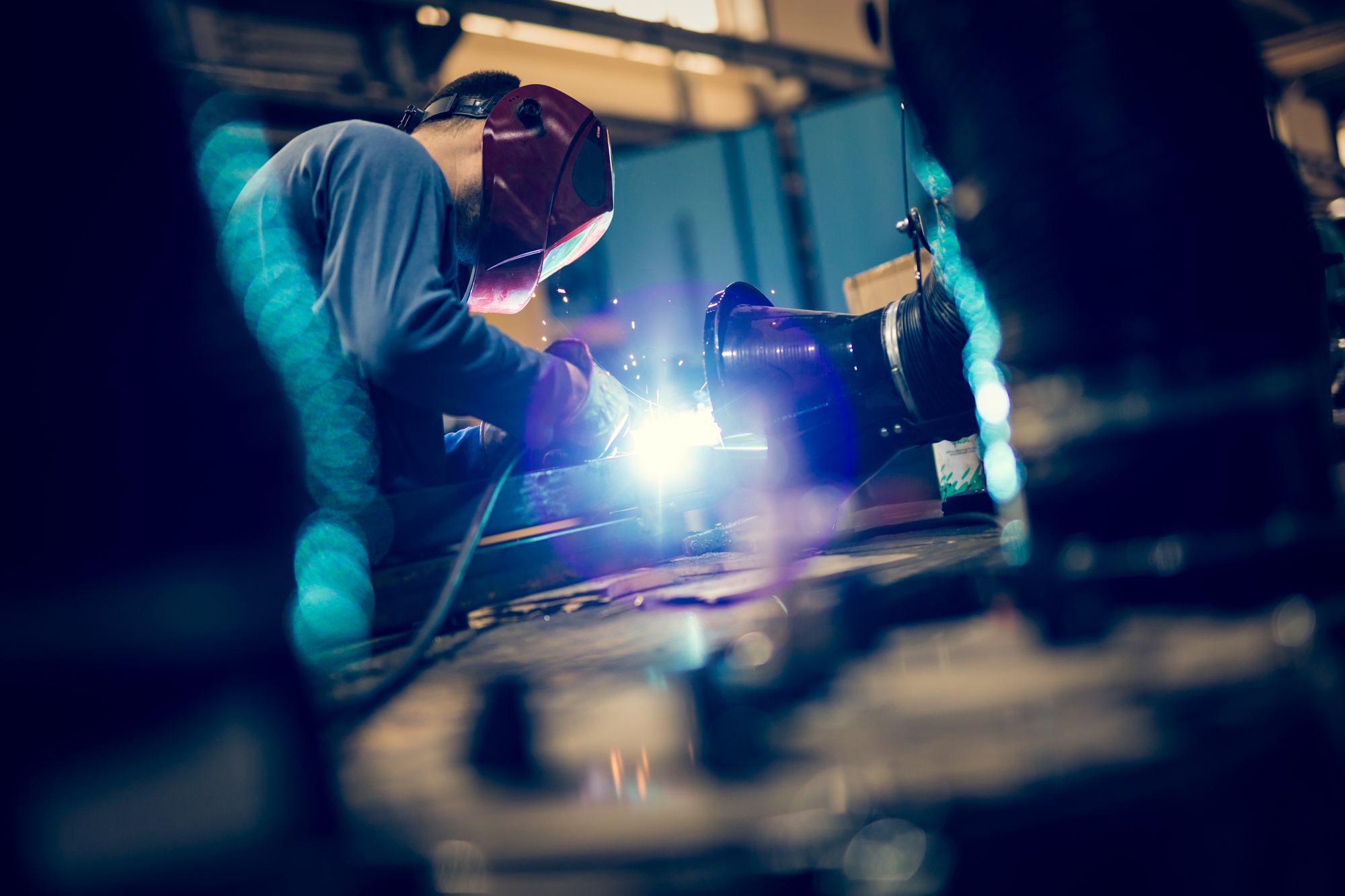 worker using mig welder