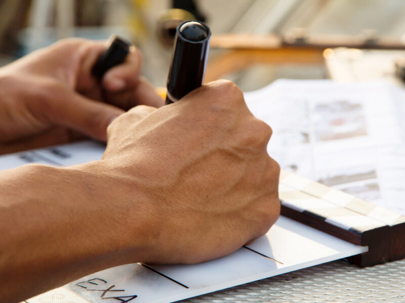 site survey man writing on piece of paper with black pen
